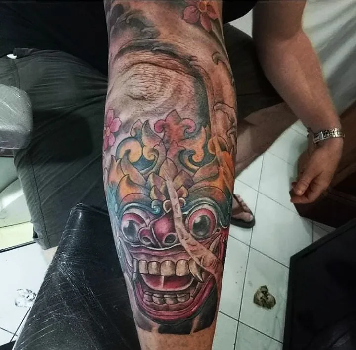Colour Balinese mask tattoo on a lower leg, Canggu Bali