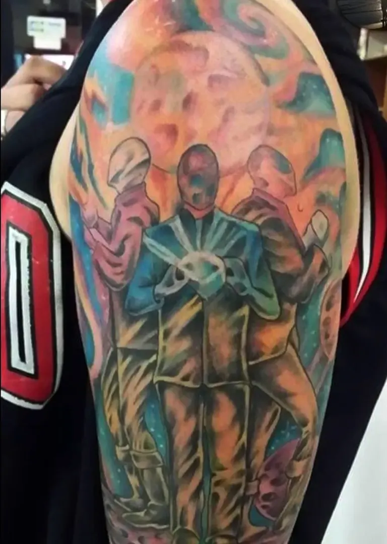 Colour half sleeve tattoo with three figures on an upper arm, Canggu Bali